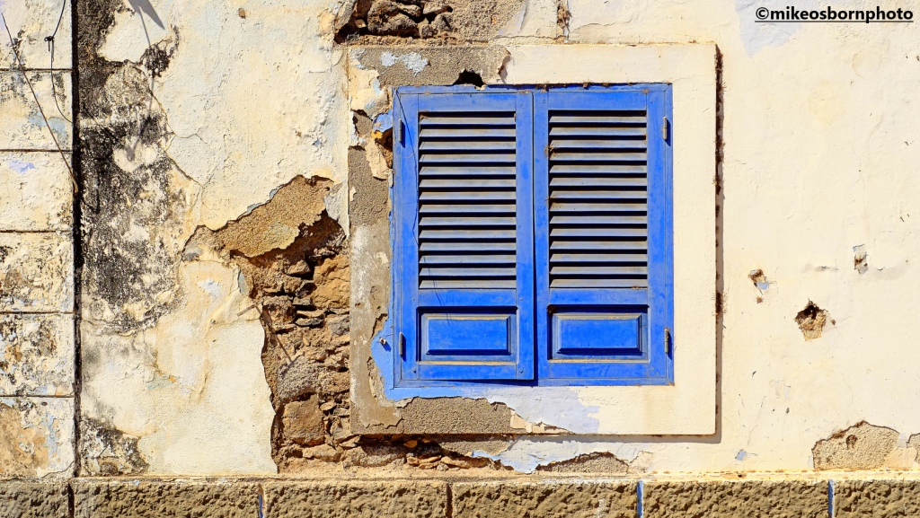 A shuttered window on a tumbleown building in Cidade Velha, Cape Verde