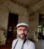 The author pictured in a dilapidated old plantation building in São Tomé.