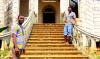 Two tour guides pose on the dilapidated stairway of Roça Agua-Ize in São Tomé.